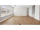 Bright living room with hardwood floors, crown molding, large windows, and neutral wall color at 1801 Angelonia Way, Fuquay Varina, NC 27526