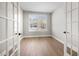 Office space with wood floor, a large window, and glass paneled doors at 1801 Angelonia Way, Fuquay Varina, NC 27526