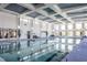 Gorgeous indoor pool with high ceilings, a trellis design, and large window-lined walls at 1801 Angelonia Way, Fuquay Varina, NC 27526