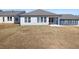 New construction home boasts a spacious backyard with newly seeded lawn and neutral colored siding at 1805 Angelonia Way, Fuquay Varina, NC 27526