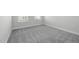 Carpeted bedroom with neutral walls, a window with blinds, and base molding at 1805 Angelonia Way, Fuquay Varina, NC 27526