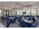 Elegant dining area features rows of tables and chairs underneath modern chandelier lighting at 1805 Angelonia Way, Fuquay Varina, NC 27526