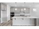 Modern kitchen featuring pendant lighting, stainless appliances, a large island, and stylish backsplash at 1805 Angelonia Way, Fuquay Varina, NC 27526
