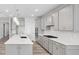 Well-equipped kitchen featuring an island, gas range, stylish backsplash, and ample cabinet space at 1805 Angelonia Way, Fuquay Varina, NC 27526