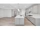 Modern kitchen showcasing an island, gas range, lots of cabinets, and open layout to the living area at 1805 Angelonia Way, Fuquay Varina, NC 27526