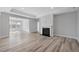 Spacious living room featuring hardwood floors, fireplace, neutral paint, and large open space at 1805 Angelonia Way, Fuquay Varina, NC 27526