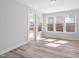 Bright sunroom with tile floors, large windows, and a door leading to the outdoor space at 1805 Angelonia Way, Fuquay Varina, NC 27526