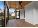 Beautiful screened-in back porch featuring a wooden ceiling with ceiling fan and paneled walls at 1886 Mays Crossroad Rd, Louisburg, NC 27549