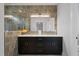 Contemporary bathroom featuring double vanity, sleek lighting and tiled walls at 1886 Mays Crossroad Rd, Louisburg, NC 27549