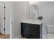 Bathroom showcasing dark vanity, modern mirror, and stylish lighting at 1886 Mays Crossroad Rd, Louisburg, NC 27549