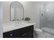 Bathroom featuring a modern vanity, sleek mirror, and glass enclosed shower at 1886 Mays Crossroad Rd, Louisburg, NC 27549