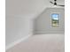 Bright bonus room featuring neutral carpet, a large window offering pleasant views, and ample space at 1886 Mays Crossroad Rd, Louisburg, NC 27549