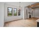 Bright dining area featuring wood flooring, ship lap walls, and black frame windows at 1886 Mays Crossroad Rd, Louisburg, NC 27549