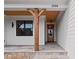 Charming front porch showcasing stone floors, wood supports, wood ceiling and stylish entrance at 1886 Mays Crossroad Rd, Louisburg, NC 27549