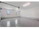 Clean and spacious garage with epoxy flooring, overhead lighting and natural light from windows at 1886 Mays Crossroad Rd, Louisburg, NC 27549
