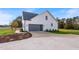 Attached garage with large gray doors and a concrete driveway at 1886 Mays Crossroad Rd, Louisburg, NC 27549