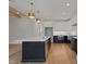 Modern kitchen with a large island, stylish pendant lighting, and stainless steel appliances at 1886 Mays Crossroad Rd, Louisburg, NC 27549