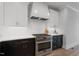 Close up of gourmet kitchen features, stainless steel range, white cabinets, and black lower cabinets at 1886 Mays Crossroad Rd, Louisburg, NC 27549