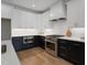 Well-lit kitchen with stainless steel appliances, white cabinets and striking black lower cabinets at 1886 Mays Crossroad Rd, Louisburg, NC 27549