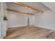Spacious living area with hardwood floors, beam accents, and modern lighting at 1886 Mays Crossroad Rd, Louisburg, NC 27549