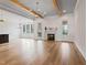 Open concept living area with wood flooring, beamed ceiling, and a fireplace at 1886 Mays Crossroad Rd, Louisburg, NC 27549
