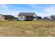 Back exterior view of modern farmhouse with screened porch and deck in a large yard at 1886 Mays Crossroad Rd, Louisburg, NC 27549