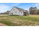 Rear view of modern farmhouse-style home featuring a screened-in porch and attached garage with modern door at 1886 Mays Crossroad Rd, Louisburg, NC 27549