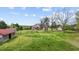 Vast backyard with mature trees, outbuildings, and plenty of open space for outdoor activities at 2011 Gibsonville Ossipee Rd, Elon, NC 27244