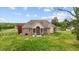 Spacious backyard with a covered patio ideal for outdoor relaxation and entertaining at 2011 Gibsonville Ossipee Rd, Elon, NC 27244