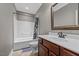 Bathroom featuring a shower/tub combination and a vanity with a decorative framed mirror at 2011 Gibsonville Ossipee Rd, Elon, NC 27244