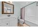 Bright bathroom featuring a tiled shower-tub combo and a white vanity at 2011 Gibsonville Ossipee Rd, Elon, NC 27244