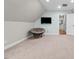 Spacious room with papasan chair, wall-mounted TV, and ensuite bathroom at 2011 Gibsonville Ossipee Rd, Elon, NC 27244