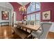 Elegant dining room featuring a decorative chandelier, large windows and stylish seating at 2011 Gibsonville Ossipee Rd, Elon, NC 27244