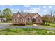 Charming brick home with a well-manicured lawn and inviting front entrance at 2011 Gibsonville Ossipee Rd, Elon, NC 27244
