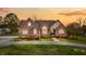 Charming brick home with a well-manicured lawn and inviting front entrance at sunset at 2011 Gibsonville Ossipee Rd, Elon, NC 27244