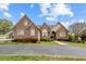 Attractive brick home featuring an inviting front entrance, arched windows, and landscaped grounds at 2011 Gibsonville Ossipee Rd, Elon, NC 27244