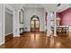 Grand foyer with hardwood floors, decorative columns, and a chandelier at 2011 Gibsonville Ossipee Rd, Elon, NC 27244