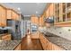 Well-equipped kitchen with wooden cabinets, stainless steel appliances, and granite countertops at 2011 Gibsonville Ossipee Rd, Elon, NC 27244