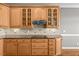 Spacious kitchen featuring wood cabinets, granite countertops, tile backsplash, and modern appliances at 2011 Gibsonville Ossipee Rd, Elon, NC 27244