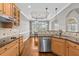 Open kitchen featuring wood cabinets, granite counters, stainless steel appliances, and hardwood floors at 2011 Gibsonville Ossipee Rd, Elon, NC 27244