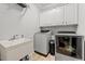 Laundry room with sink, cabinets, and modern washer and dryer at 2011 Gibsonville Ossipee Rd, Elon, NC 27244