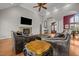 Cozy living room with stone fireplace, hardwood floors, leather furniture, and ample natural light at 2011 Gibsonville Ossipee Rd, Elon, NC 27244