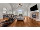 Bright living room with hardwood floors, a stone fireplace, and comfortable leather furniture at 2011 Gibsonville Ossipee Rd, Elon, NC 27244
