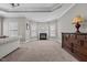 Inviting living room with a fireplace, neutral walls and carpet, and a large dresser at 2011 Gibsonville Ossipee Rd, Elon, NC 27244