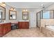 Main bathroom with a walk-in shower, soaking tub, dual sinks, and tile flooring at 2011 Gibsonville Ossipee Rd, Elon, NC 27244