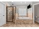 Luxurious main bathroom featuring a walk-in shower, soaking tub, and tile accents at 2011 Gibsonville Ossipee Rd, Elon, NC 27244