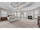 Large main bedroom with tray ceiling, carpet, and fireplace at 2011 Gibsonville Ossipee Rd, Elon, NC 27244