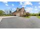 Spacious paved driveway leading to a two-story brick home with an attached garage at 2011 Gibsonville Ossipee Rd, Elon, NC 27244