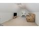 Finished attic featuring a comfortable couch, TV, and exercise bike at 2013 Magnolia Tree Ln, Durham, NC 27703