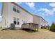Exterior view of backyard with wood deck and vinyl siding of the house at 2013 Magnolia Tree Ln, Durham, NC 27703